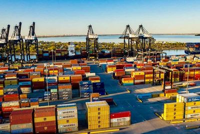 Hundreds of shipping containers sitting at port.