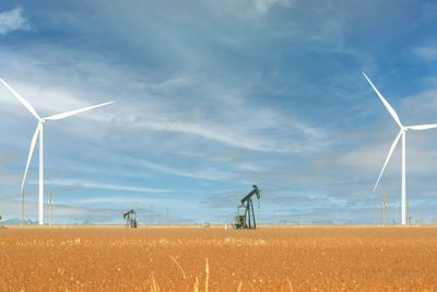 Pump jacks and wind turbines on the same field